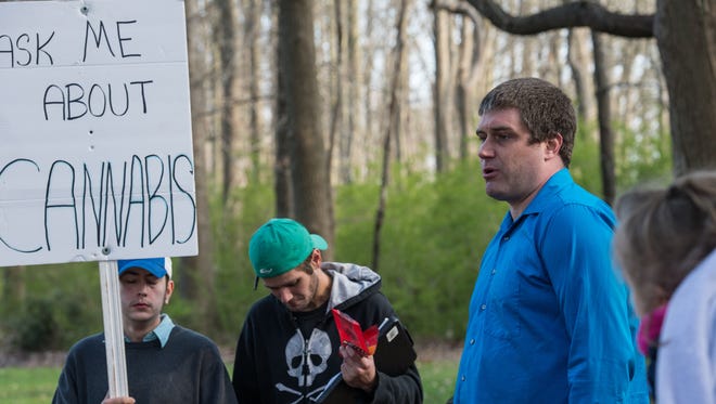 Jerad Halcott, right, speaks to a crowd during a protest at Maryland State Police Barrack V in Berlin on Wednesday, April 11, 2018.
