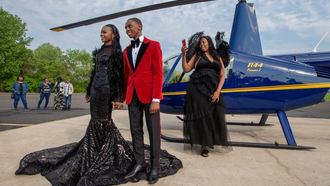 Saudia Shuler, right, films her son, Nieme Brooker with his date Tiana Johnson in this James Bond-style prom send-off on May 12, 2018. They attended the Penn Wood prom later that evening. (Charles Fox /The Philadelphia Inquirer via AP)