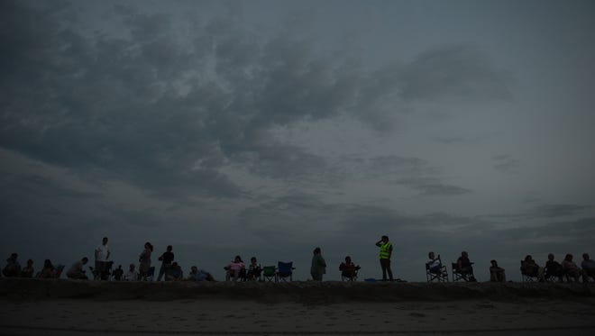 Spectators set up on the beach just before sunrise to wait for the northern herd to be led to their corral on Assateague Island, Va. on Monday morning, July 25, 2016. The 91st Annual Chincoteague Pony Swim is Wednesday.