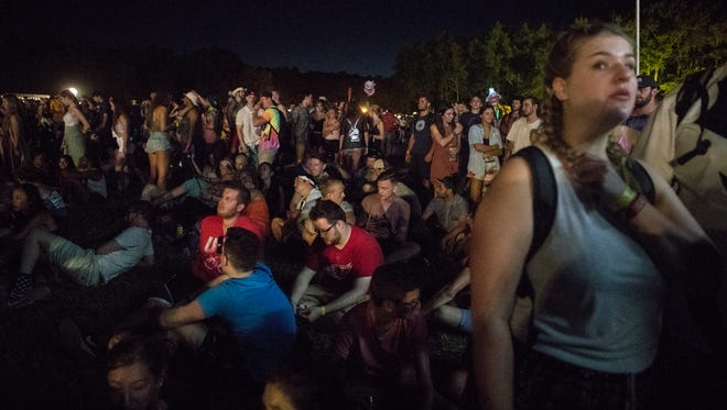 Festival goers explore the first night of live music and activities at Firefly Music Festival Thursday in Dover.