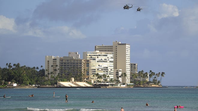 Helicopters patrol over Waikiki beach Nov. 10, 2011.