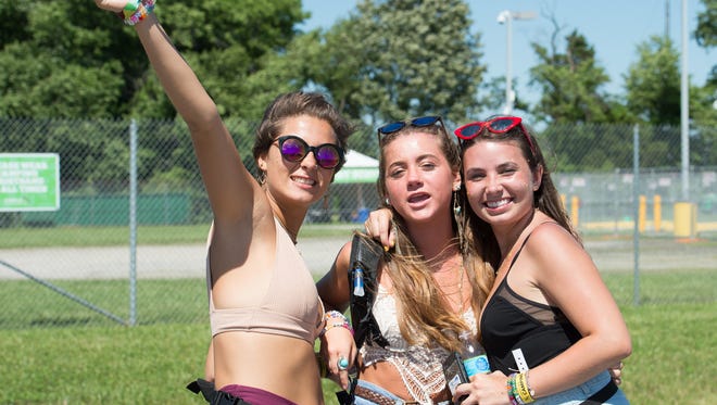 Geneva Foster, left, Emily Woessner and Rachel Quimby of Easton, Md., pose for a photo at the Firefly Music Festival in Dover.