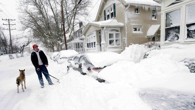 Dominic Fontana, 28, of New Caslte, helps a friend by digging out cars on 6th Street in Old New Castle Saturday, February 6, 2010.