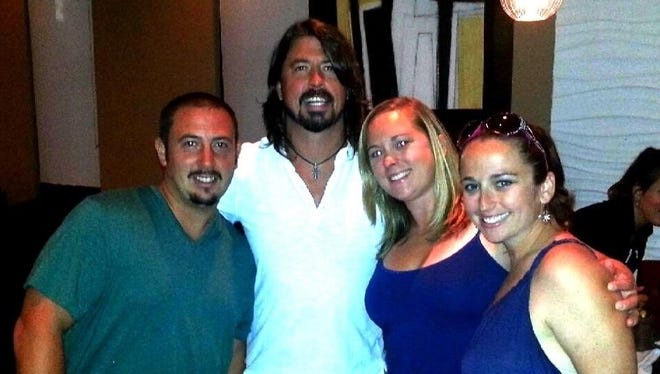 Dave Grohl of the Foo Fighters with Wilmington's  Josh Moccia Jenny Moccia and Kimberly Walker at Saketumi  in Rehoboth Beach in 2013.
