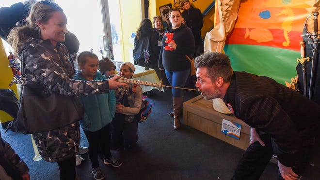 Amy Elliott of Dagsboro with her daughter, Bre Elliott, 8, pulls a sword out of Tyler Fyre's mouth at the Odditorium Grand Reopening of Ripley's Believe It or Not! on the Boardwalk in Ocean City Saturday, March 10, 2018.