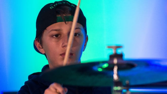 Brennan Kaiser, 13, plays the drums during a rehearsal at AMP Studio on Monday, Nov. 20, 2017.