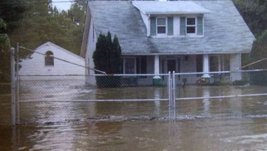 Floodwaters from a storm surround a Marshallton home in 2004, during one of the incidents that prompted a more-than decade-long effort to rewrite state stormwater and erosion-control regulations.