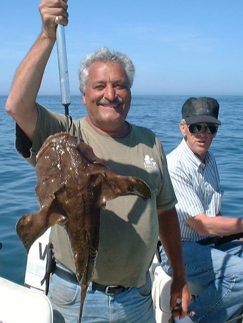 George Hill and Pete Foraker hold an anglerfish caught near D buoy.