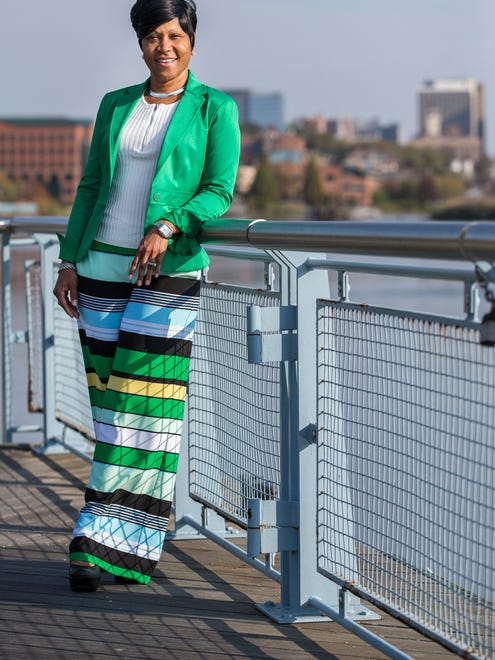 Doranna Clemment wears green, yellow and black striped palazzo pants; white ribbed pullover quarter-length sweater with crew neck; 7th Ave green blazer; and black leather platform wedges by Kork-Ease, all from New York & Co.