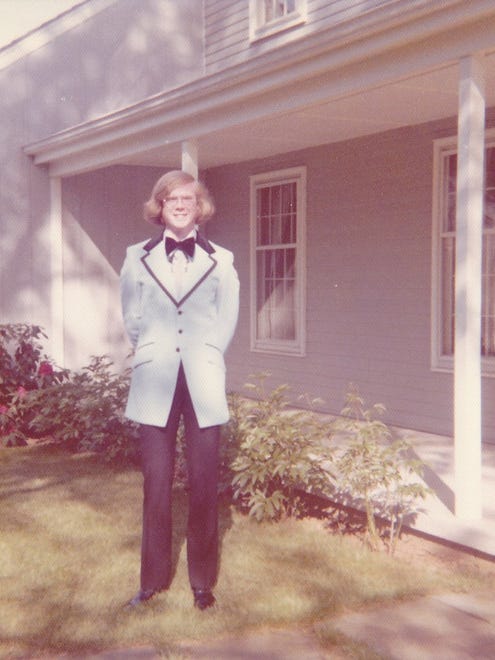 Chris Mulligan poses in front of his parents house for a pre-prom photo that was taken against his wishes. He went to Sanford School's May 1973 prom.