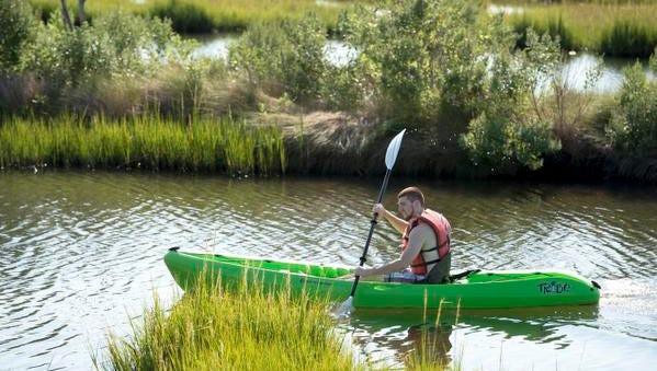 Ben VanBloem breaks away from the group to explore a marsh at Assateague Island National Seashore during a tour guided by SuperFun Eco Tours.