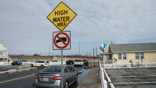 A view of a High Water warning sign on Saint Louis Avenue in Ocean City on Sunday, Nov. 5, 2017.
