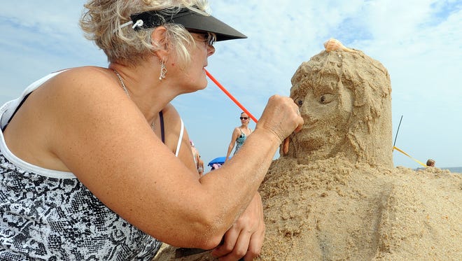 Sherri Miller from Boyerstown, PA, works on her "Neptunes Angel" at the 38th Annual Rehoboth Beach-Dewey Beach Chamber of Commerce Sandcastle Contest.