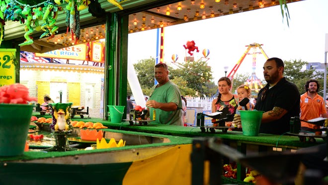 Trimper's Rides customers try their luck at the "Frog Bog." in August 2016. Trimper's is proposing to replace its duck pond with a food trailer that would remain in place all summer and sell Chick-Fil-A products.