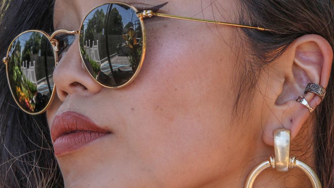 Dancer Rie Aoki wears sunglasses by Ray Ban, and jewelry by Free People Sunday, July 2, 2017, at Brew HaHa! in Greenville.