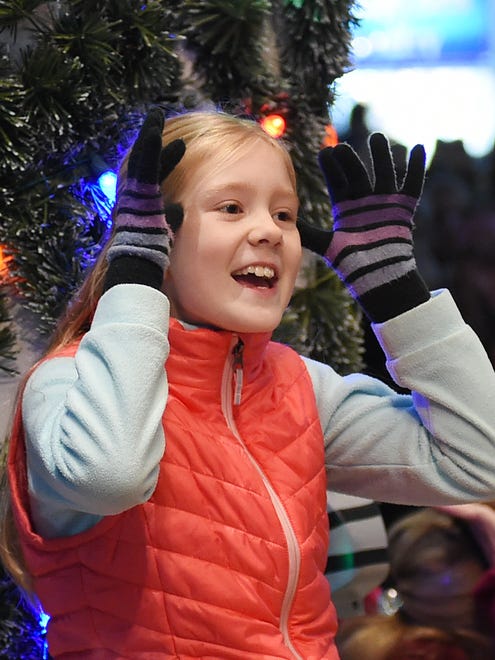A girl takes part in "Rudolph the Red-Nosed Reindeer" during Rehoboth Beach's annual Christmas tree lighting ceremony at the Bandstand on Friday, Nov. 24, 2017.