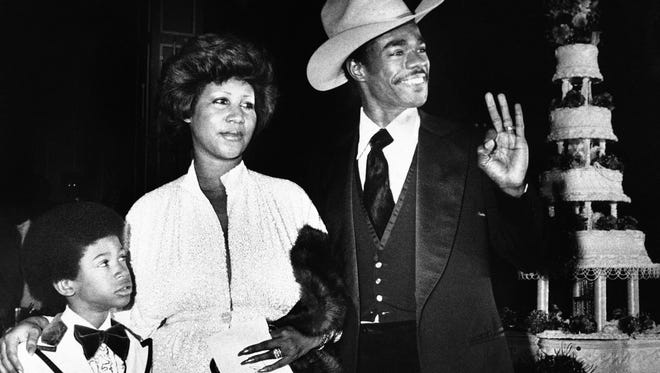 Aretha Franklin and her new husband, Glen Turman, arrive at a Los Angeles hotel, April 17, 1978 for their wedding reception. Turman signals his okay and pleasure at the reception as Kecalf, Aretha's son by a previous marriage looks on. The couple married recently, had planned a reception at her Beverly Hills home on Saturday but the party was rained out, and moved to the hotel for the Sunday party.
