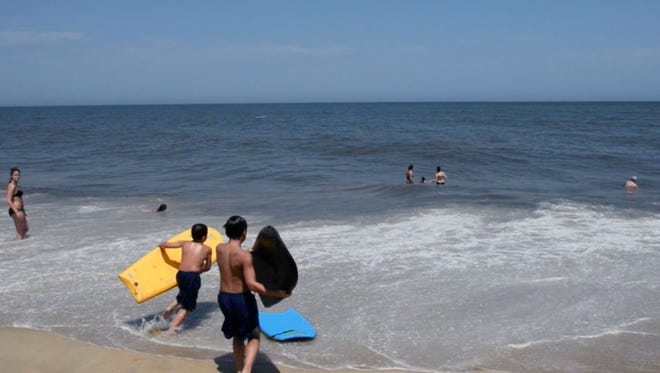 Kids in Dewey Beach take to the waves on Thursday, July 3, before tropical storm Arthur is forecasted to come through.