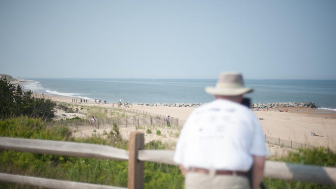 A photographer takes a photo at Herring Point at Cape Henlopen State Park.