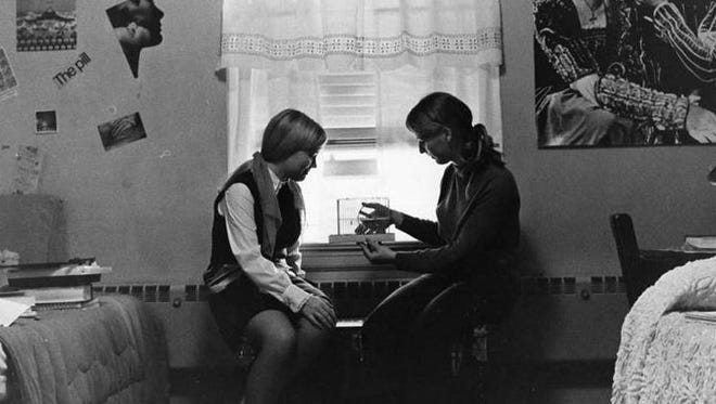 1971: Roommates at Salisbury University compare notes in their dorm room.