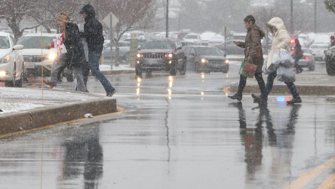 Shoppers at Concord Mall are undeterred by snow early Saturday afternoon,