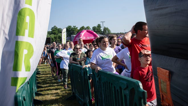 The Great Inflatable Race started at 9:00am in Shrewsbury, Pa. on Saturday, July 14, 2018. People waiting in line to clime the first obstacle course. Some participants wear their own costumes and others a t-shirt from the event.