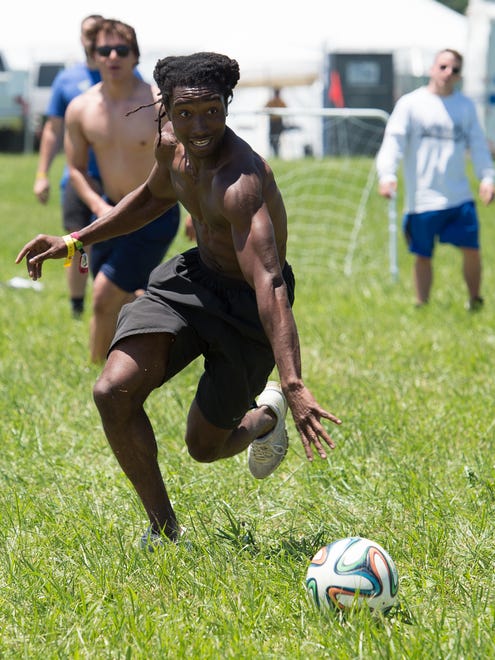 Jabiri Hawkins of Silver Springs, Md., plays soccer on a field that the Firefly Music Festival set up in the north camping area, a request that festival goers ask for this year.