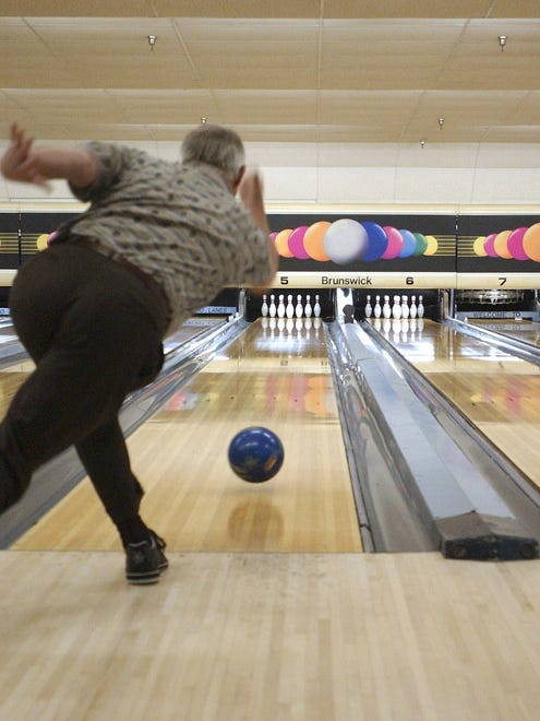 A bowler takes a few practice shots before league play at Millsboro Lanes