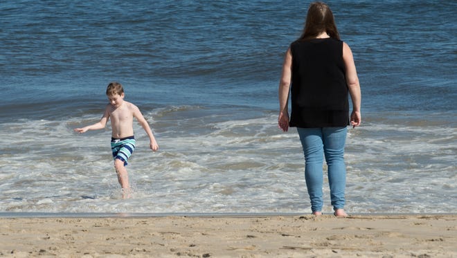 Earle Schulz (9) and his mother, Alicia Quigley, of Brooklyn, New York enjoy a warm day at Rehoboth Beach.