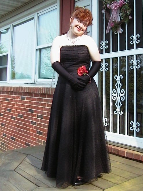 Ashley Hall modeling her 2002 prom dress.