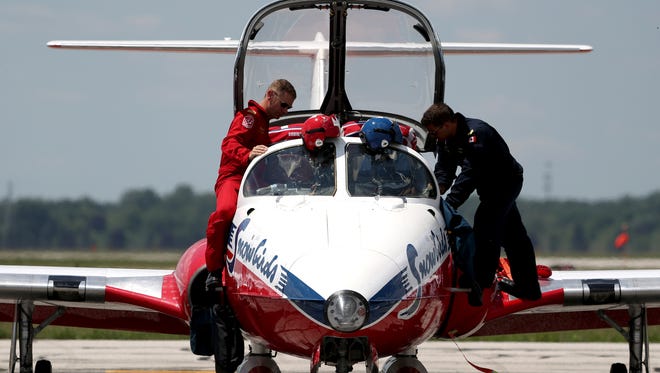 (L to R) Canadian Forces Snowbirds pilot Steve Reed and his structural technician Marc De-Serres get out of their CL 41 Tutor after landing at Willow Run Airport in Ypsilanti.