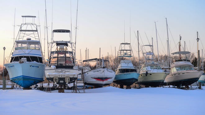 Boats sit in a snow covered boat yard on Friday, Jan. 5, 2018 in Lewes, Del.