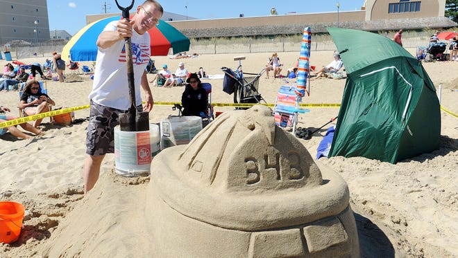Larry Murray a firefighter from Maryland works the sand to honor the 9/11 Event as  Great weather had many beach artists attend the Rehoboth Beach-Dewey Beach Chamber of Commerce's Annual Sandcastle Contest held on the beach at Brooklyn Avenue in Rehoboth Beach on Saturday September 9th.
Special to the Daily Times / CHUCK SNYDER
