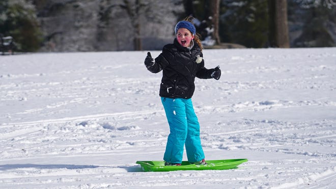 9 year-old Abby O'Connor gives the thumbs up on her successful ride down hill at Rockford Park in February 2017.