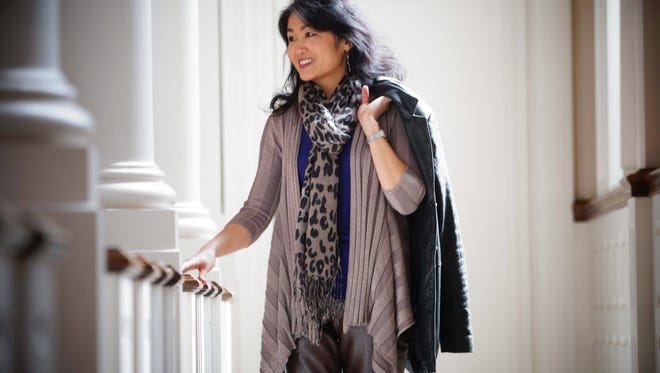 Pianist Hiroko Yamazaki wears brown Gap leather pants, a purple silk/cotton/cashmere DKNY tank top and a metallic INC draped cardigan with a black leather jacket by Avanti.