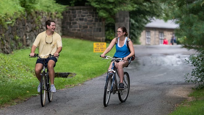 Maxwell Baker of North East, Maryland, and Emily Biffen of Wilmington enjoy the Bike & Hike event at Hagley Museum in Wilmington despite some unplanned rain.