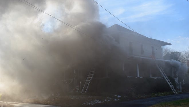 Firefighters work at the scene of a blaze at a residence in Berlin on Tuesday, Dec. 12.