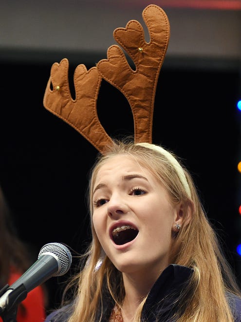 Grace Morris, 15, belts out the theme from "Frozen" at Rehoboth Beach's annual Christmas tree lighting ceremony at the Bandstand on Friday, Nov. 24, 2017.