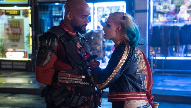Deadshot (Will Smith) and Harley Quinn (Margot Robbie) discuss the mission in 'Suicide Squad.'