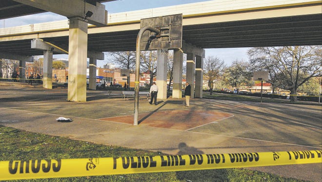 Police tape cordens off the basketball court at Second and Jackson streets under I-95 in Wilmington in mid-April, after 23-year-old Jamar Brown was fatally shot during a game there. Although the incident happened in broad daylight, his killer has not been identified.