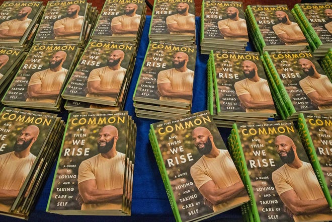 Copies of And Then We Rise: A Guide to Loving and Taking Care of Self by rapper, actor, writer and activist Common are featured in advance of the book talk and signing event at the Wilmington Public Library on Friday, Jan 26, 2024. A capacity crowd of approximately 350 people attended.