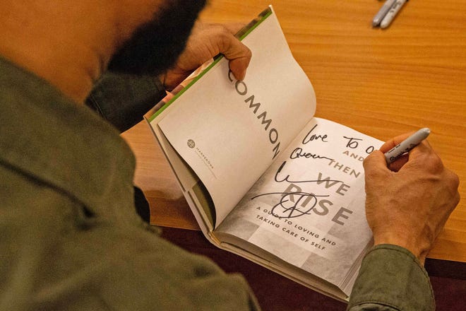 Common, rapper, actor, writer and activist, signs his book And Then We Rise: A Guide to Loving and Taking Care of Self at a book talk and signing event at the Wilmington Public Library on Friday, Jan 26, 2024. A capacity crowd of approximately 350 people attended.