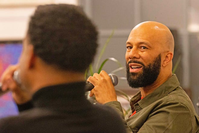 Common, rapper, actor, writer and activist, fields questions from moderator Forrest Foster, Assistant Dean of Libraries and Associate Professor at North Carolina's A&T, during a book talk and signing event for And Then We Rise: A Guide to Loving and Taking Care of Self at the Wilmington Public Library on Friday, Jan 26, 2024. A capacity crowd of approximately 350 people attended.