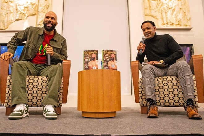 Common, rapper, actor, writer and activist, reacts as he fields questions from moderator Forrest Foster, Assistant Dean of Libraries and Associate Professor at North Carolina's A&T, during a book talk and signing event for And Then We Rise: A Guide to Loving and Taking Care of Self at the Wilmington Public Library on Friday, Jan 26, 2024. A capacity crowd of approximately 350 people attended.