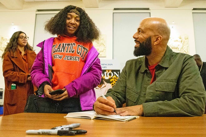 A fan gets her book signed by Common, rapper, actor, writer and activist, during a book talk and signing event for his book And Then We Rise: A Guide to Loving and Taking Care of Self at the Wilmington Public Library on Friday, Jan 26, 2024. A capacity crowd of approximately 350 people attended.