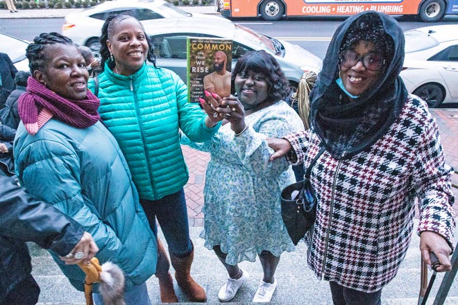 "I came because I remember he sang Glory around the time my father passed away, that touched me," said Lorraine Muhammad, at far right, who along with other fans wait to enter the book talk and signing event for And Then We Rise: A Guide to Loving and Taking Care of Self a book by Common, rapper, actor, writer and activist, at the Wilmington Public Library on Friday, Jan 26, 2024. A capacity crowd of approximately 350 people attended.