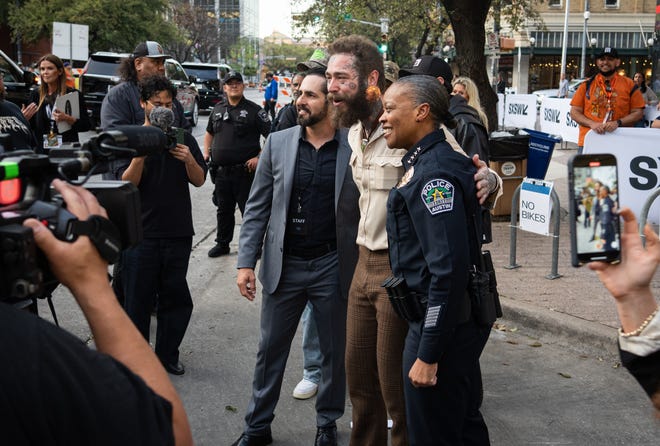 Post Malone takes a photo with Austin Police Chief Robin Henderson, right, before the premiere of Road House at the Paramount Theatre in Austin, Texas on the first day of South by Southwest, Friday, March 8, 2024.