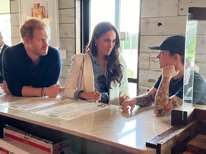 Prince Harry and Meghan Markle visited La Barbecue in Austin and talked with restaurant owner Ali Clem (right).