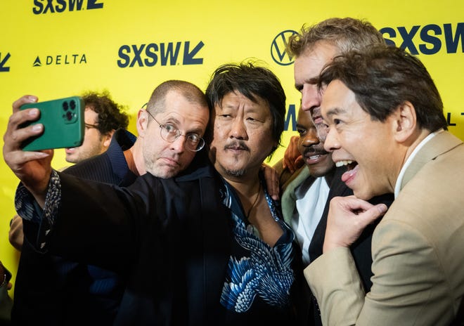 Benedict Wong, center, takes a selfie with D.B. Weiss, left, Jovan Adepo, David Benioff, and Alexander Woo on the red carpet at the premiere of 3 Body Problem at the Paramount Theatre in Austin, Texas on the first day of South by Southwest, Friday, March 8, 2024.