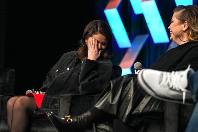 Selena Gomez, an American actress and founder of Wondermind, covers her face during introductions at a featured session on mental health during South by Southwest at the Austin Convention Center on Sunday, March 10, 2024.